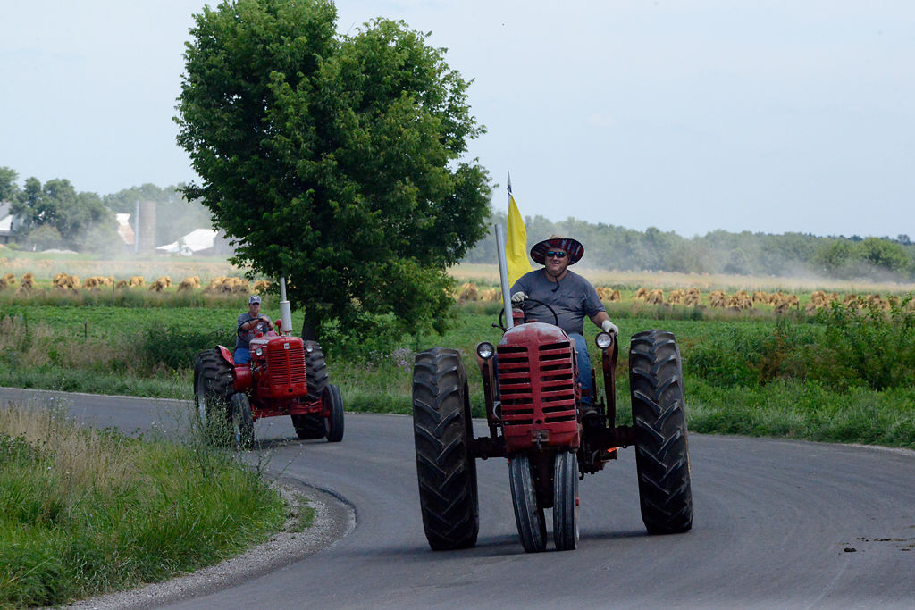 Jerry Forsee, front, drives his tractor back into town